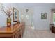 Inviting foyer featuring a wooden console table with elegant decor and light tile flooring at 309 South Dr, Nokomis, FL 34275