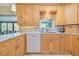 Bright kitchen with updated marble countertops, stainless sink, and wood cabinetry and a water view at 309 South Dr, Nokomis, FL 34275