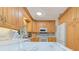 Well-lit kitchen with white appliances, wood cabinetry, sleek countertops, and modern finishes at 309 South Dr, Nokomis, FL 34275