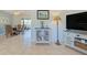 Open living space with view to dining area and patio, with neutral tones, tile flooring, and bright, natural light at 309 South Dr, Nokomis, FL 34275