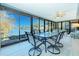 Bright sunroom features large windows with a beautiful lake view, offering a serene dining experience at 309 South Dr, Nokomis, FL 34275
