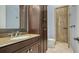 Bathroom with granite countertop and walk-in shower at 3365 Bayou Gate, Longboat Key, FL 34228