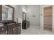 Bathroom with single vanity, large mirror, and walk-in shower at 3365 Bayou Gate, Longboat Key, FL 34228