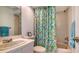 Clean bathroom with a shower/tub combo, flamingo shower curtain, and a vanity at 3371 Bayou Sound, Longboat Key, FL 34228