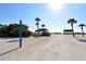 Volleyball net and beach cabanas along a sandy path leading to the waterfront at 3371 Bayou Sound, Longboat Key, FL 34228