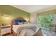 Bright bedroom with a comfortable bed and leafy window view at 3371 Bayou Sound, Longboat Key, FL 34228