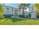 Two-story home with palm trees and manicured landscaping at 3371 Bayou Sound, Longboat Key, FL 34228