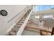 Modern staircase with metal railing and carpeted steps at 3371 Bayou Sound, Longboat Key, FL 34228