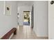 Bright hallway with tiled floor and view of backyard at 3439 Tobero Ln, Sarasota, FL 34235