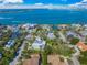 Stunning aerial view showcasing waterfront homes, lush landscaping, and sparkling water at 3445 Anglin Dr, Sarasota, FL 34242