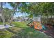 Large backyard features a playset and climbing structure, perfect for Gathering fun at 3445 Anglin Dr, Sarasota, FL 34242