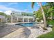 The backyard is a tropical oasis complete with a pool and spiral staircase at 3445 Anglin Dr, Sarasota, FL 34242