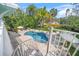 Beautiful backyard has a swimming pool, chairs, and a firepit at 3445 Anglin Dr, Sarasota, FL 34242