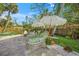 Backyard with a firepit, patio, lounge chairs and well-manicured plants at 3445 Anglin Dr, Sarasota, FL 34242