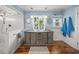 Bright bathroom with a double sink vanity with a tiled shower and natural light at 3445 Anglin Dr, Sarasota, FL 34242