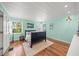 Bedroom with natural light and wood flooring, complimented by a bed and wall art at 3445 Anglin Dr, Sarasota, FL 34242