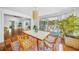 Dining room with a plant and decor, rug and sliding glass doors leading to an outdoor deck at 3445 Anglin Dr, Sarasota, FL 34242