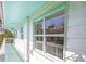 Exterior view of the home features white painted wood and turquoise trim at 3445 Anglin Dr, Sarasota, FL 34242