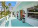 Charming front porch with seating, potted plants, and stylish lighting fixtures, perfect for relaxing outdoors at 3445 Anglin Dr, Sarasota, FL 34242