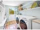 Bright laundry room features a door to the outside and a washer and dryer at 3445 Anglin Dr, Sarasota, FL 34242