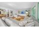 Spacious living room with terracotta floors, built-in shelving, and a large sectional sofa at 3445 Anglin Dr, Sarasota, FL 34242