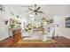 Bright living room features vaulted ceilings, ceiling fans, a fireplace, hardwood floors, and stylish décor at 3445 Anglin Dr, Sarasota, FL 34242