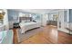 Comfortable main bedroom with hardwood floors, natural light, and soft blue colored walls at 3445 Anglin Dr, Sarasota, FL 34242
