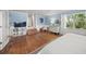 Bright main bedroom with hardwood floors, natural light, and views from windows and glass doors at 3445 Anglin Dr, Sarasota, FL 34242