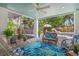 Cozy covered patio featuring comfortable seating and views of the lush backyard and pool at 3445 Anglin Dr, Sarasota, FL 34242