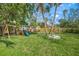 Spacious backyard with a fun playset, ideal for entertainment and play at 3445 Anglin Dr, Sarasota, FL 34242