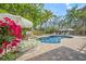 Gorgeous pool with brick patio, lounge chairs, and lush tropical landscaping at 3445 Anglin Dr, Sarasota, FL 34242