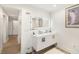 Modern bathroom with double vanity and illuminated mirror at 355 N Washington Dr, Sarasota, FL 34236