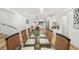 Modern dining room with a glass top table and kitchen view at 355 N Washington Dr, Sarasota, FL 34236