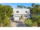 Modern two-story house with white exterior, yellow door, and landscaping at 355 N Washington Dr, Sarasota, FL 34236