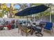 Outdoor patio with table, chairs, umbrella, and potted plants at 355 N Washington Dr, Sarasota, FL 34236