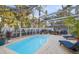 Relaxing swimming pool with lounge chairs in a screened patio area at 355 N Washington Dr, Sarasota, FL 34236