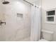 Modern shower with marble tile and white curtain at 355 N Washington Dr, Sarasota, FL 34236