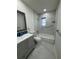 Updated bathroom with gray vanity, bathtub and marble tile at 3813 42Nd W St # 37, Bradenton, FL 34205
