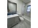 Modern bathroom with gray vanity, toilet and marble tile at 3813 42Nd W St # 37, Bradenton, FL 34205