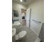 Clean bathroom with gray floor tile, white toilet and vanity at 3813 42Nd W St # 37, Bradenton, FL 34205