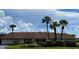 Community building exterior view with palm trees at 3813 42Nd W St # 37, Bradenton, FL 34205