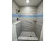 Modern shower with gray tile, blue accent tile, and a built-in seat at 3813 42Nd W St # 37, Bradenton, FL 34205