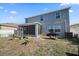 Spacious backyard with screened patio, grill, and lush landscaping at 509 Powder View Dr, Ruskin, FL 33570