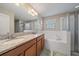Bathroom with double vanity and soaking tub at 509 Powder View Dr, Ruskin, FL 33570