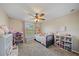 Charming bedroom with a ceiling fan, window, and built-in shelving at 509 Powder View Dr, Ruskin, FL 33570