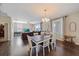 Bright dining room with farmhouse table and chairs, hardwood floors, and living room view at 509 Powder View Dr, Ruskin, FL 33570