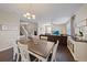 Dining room with farmhouse table, hardwood floors, and kitchen view at 509 Powder View Dr, Ruskin, FL 33570
