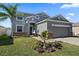 Two-story house with gray siding, stone accents, and a two-car garage at 509 Powder View Dr, Ruskin, FL 33570