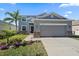 Two-story house with gray siding, stone accents, and a two-car garage at 509 Powder View Dr, Ruskin, FL 33570