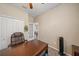 Spacious home office with wooden desk and chair, and access to another room at 509 Powder View Dr, Ruskin, FL 33570